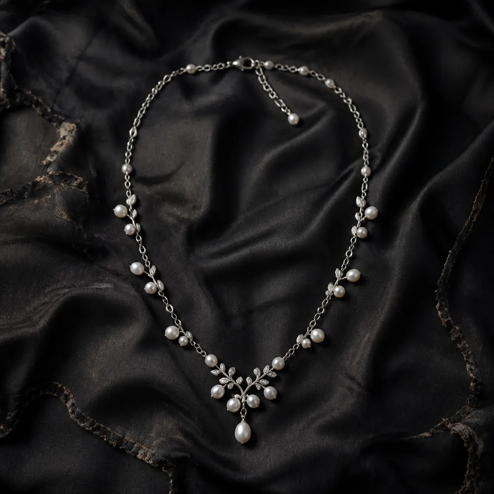 Silver and pearl necklace on black silk